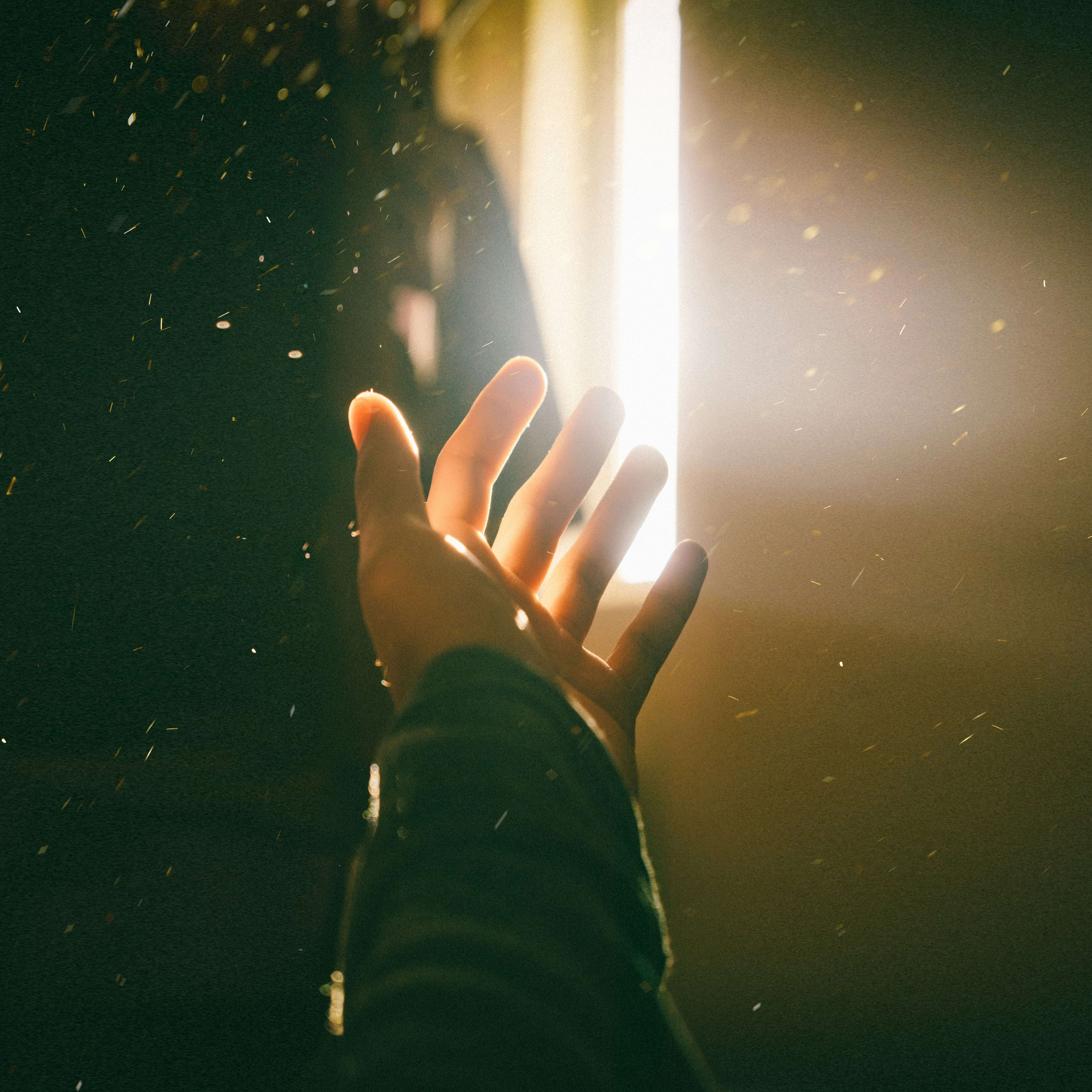Hand reaching into light